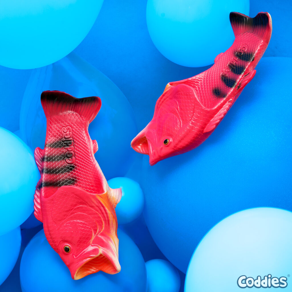 product shot of coddies fish slippers on blue baloons background